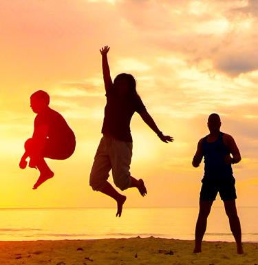 People jumping with sunset in background