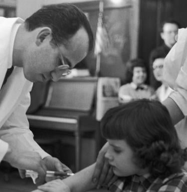 Jonas Salk administering the polio vaccine