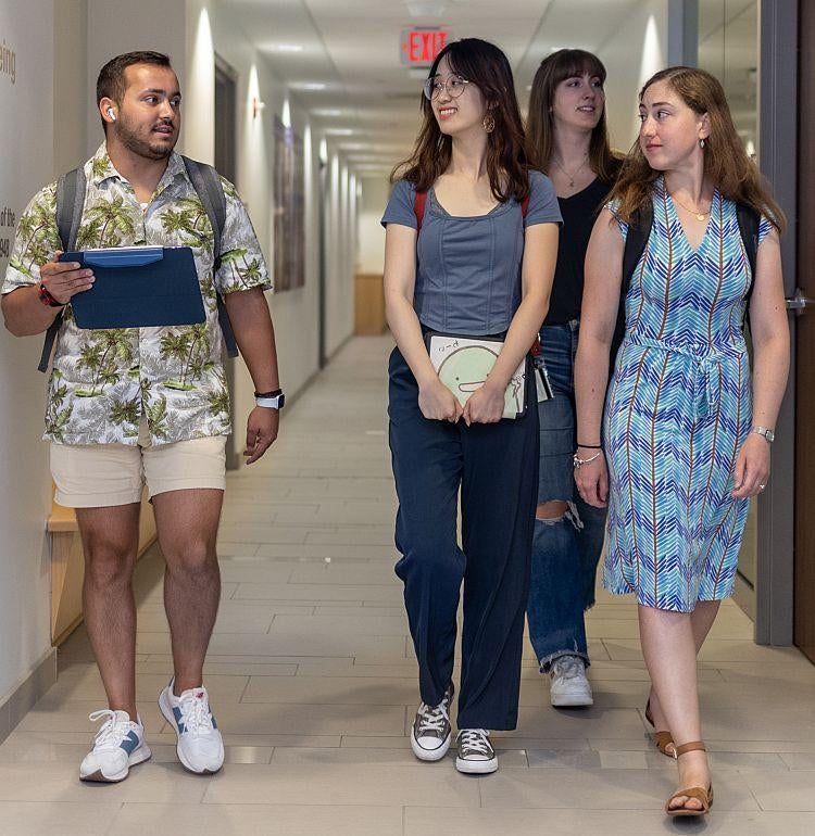 graduate students walking in hallway